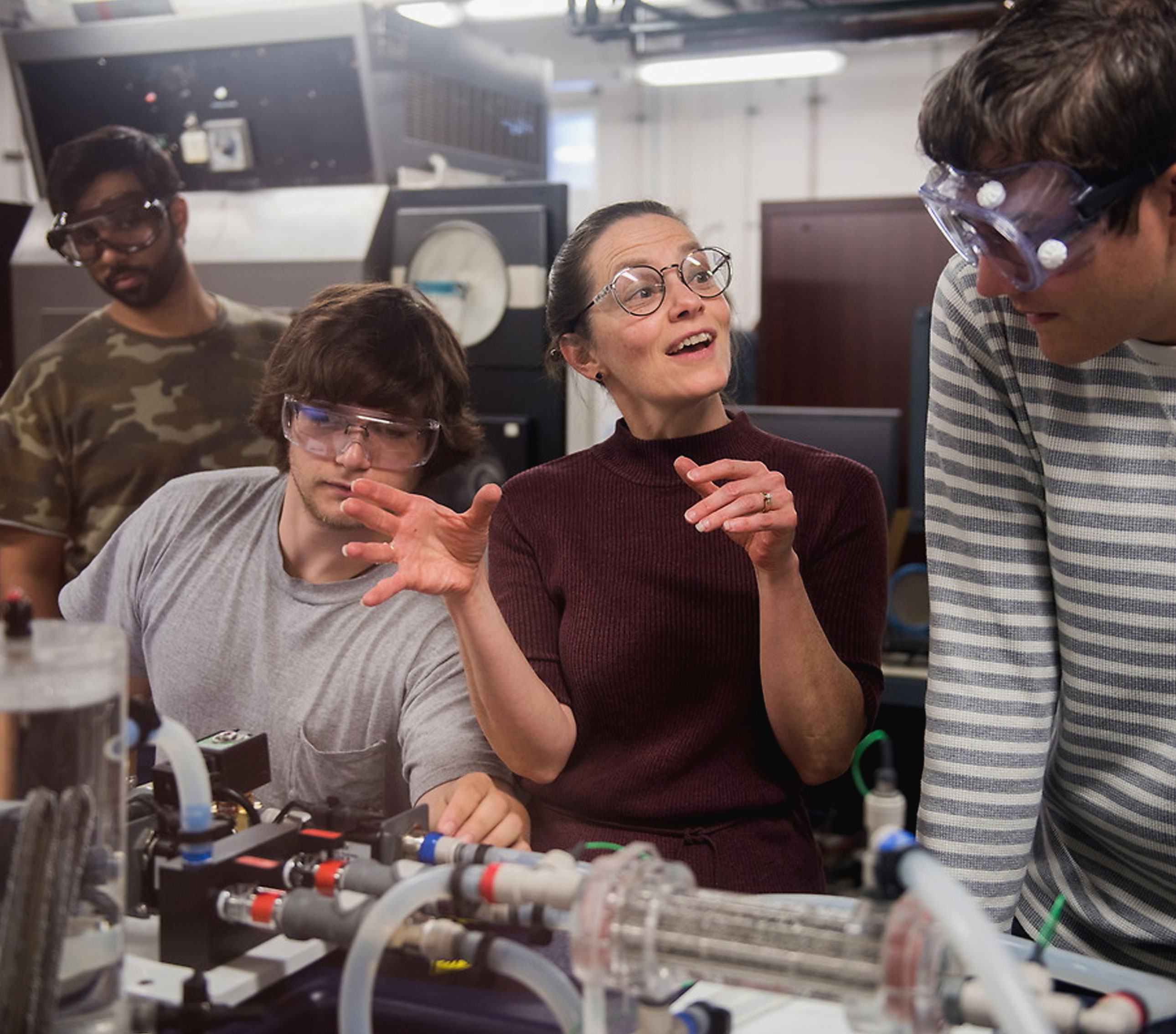 UT students work with their professor in mechanical engineering lab