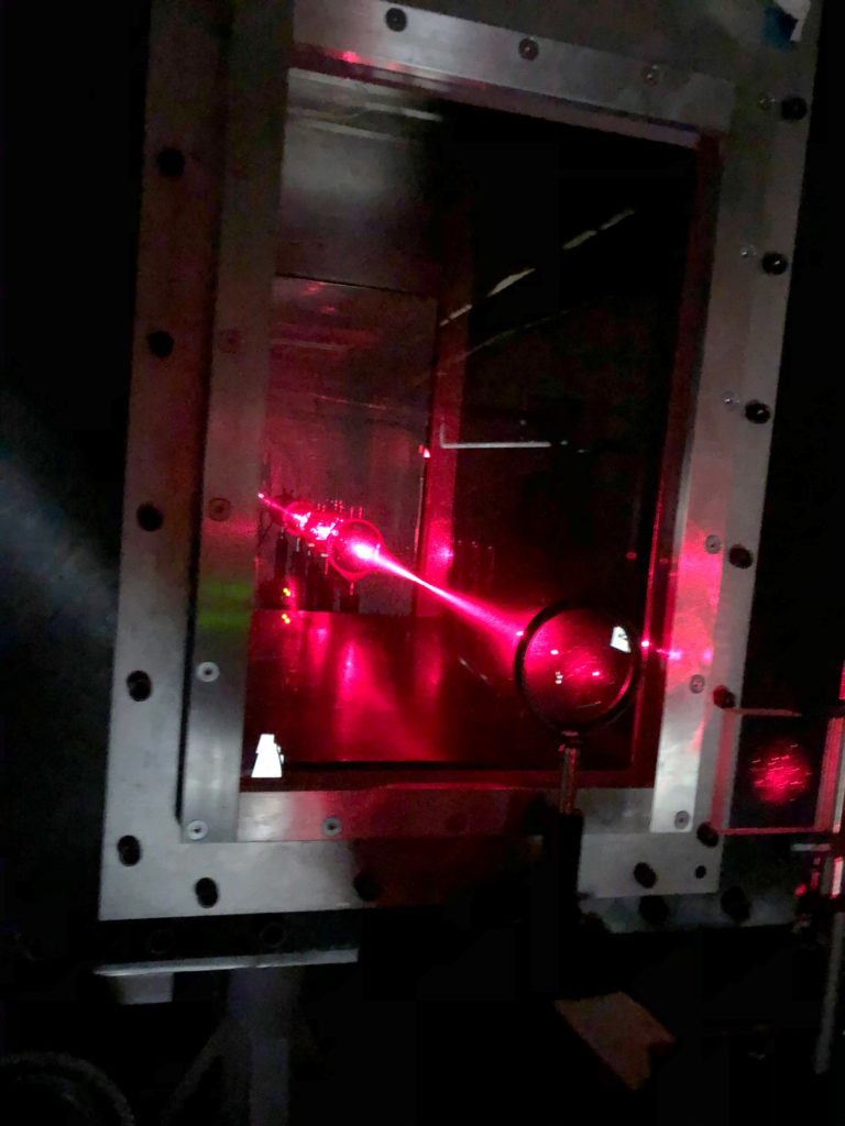 A laser sends a beam through the wind tunnel as an experiemnt