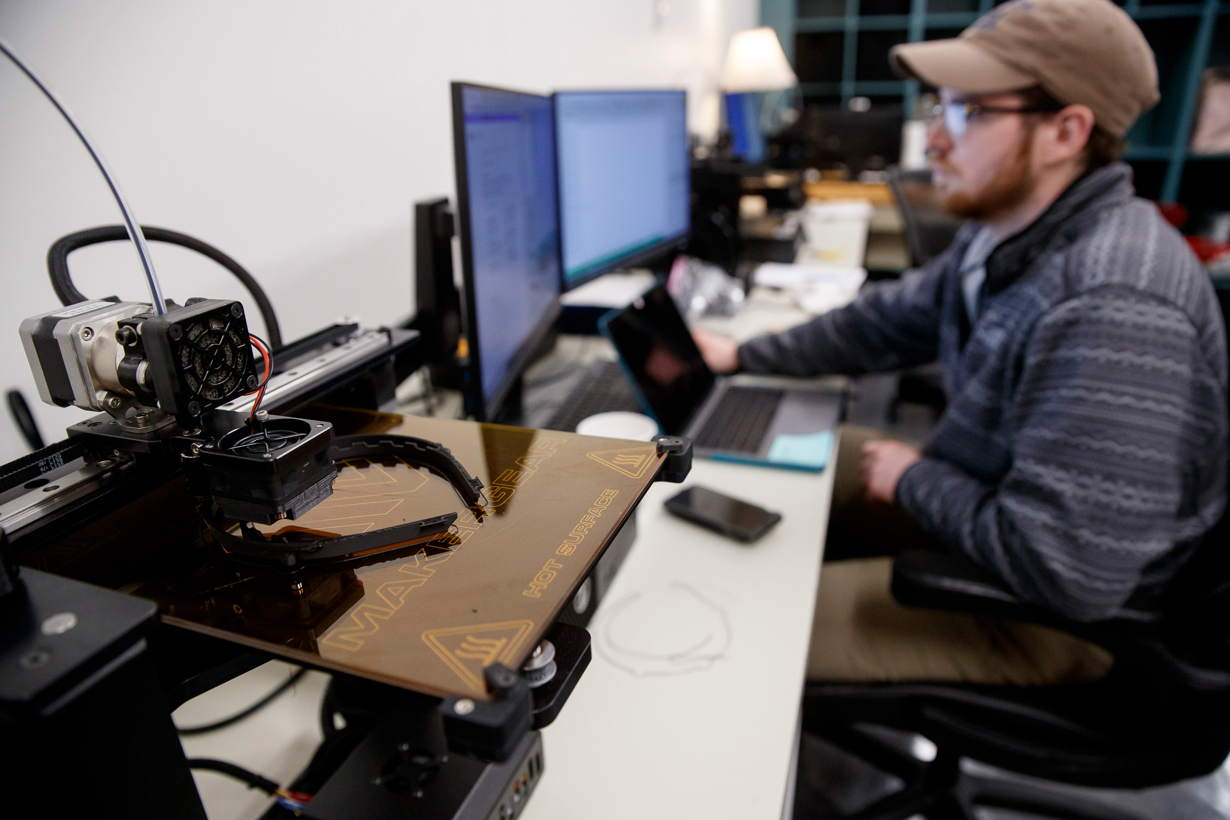 A UT Martin student works on a 3 D printer