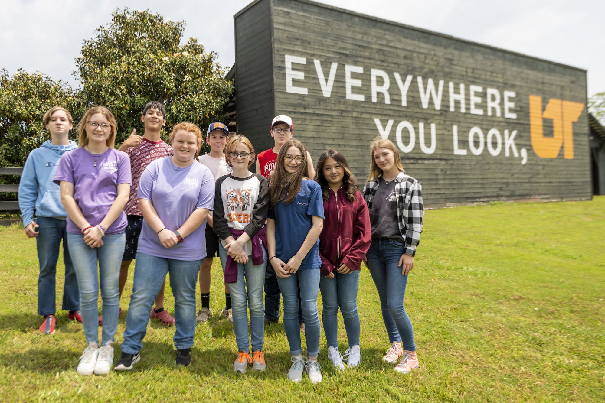 Group photo of 4-H students in front of UT mural at Lone Oaks Farm in Hardeman County