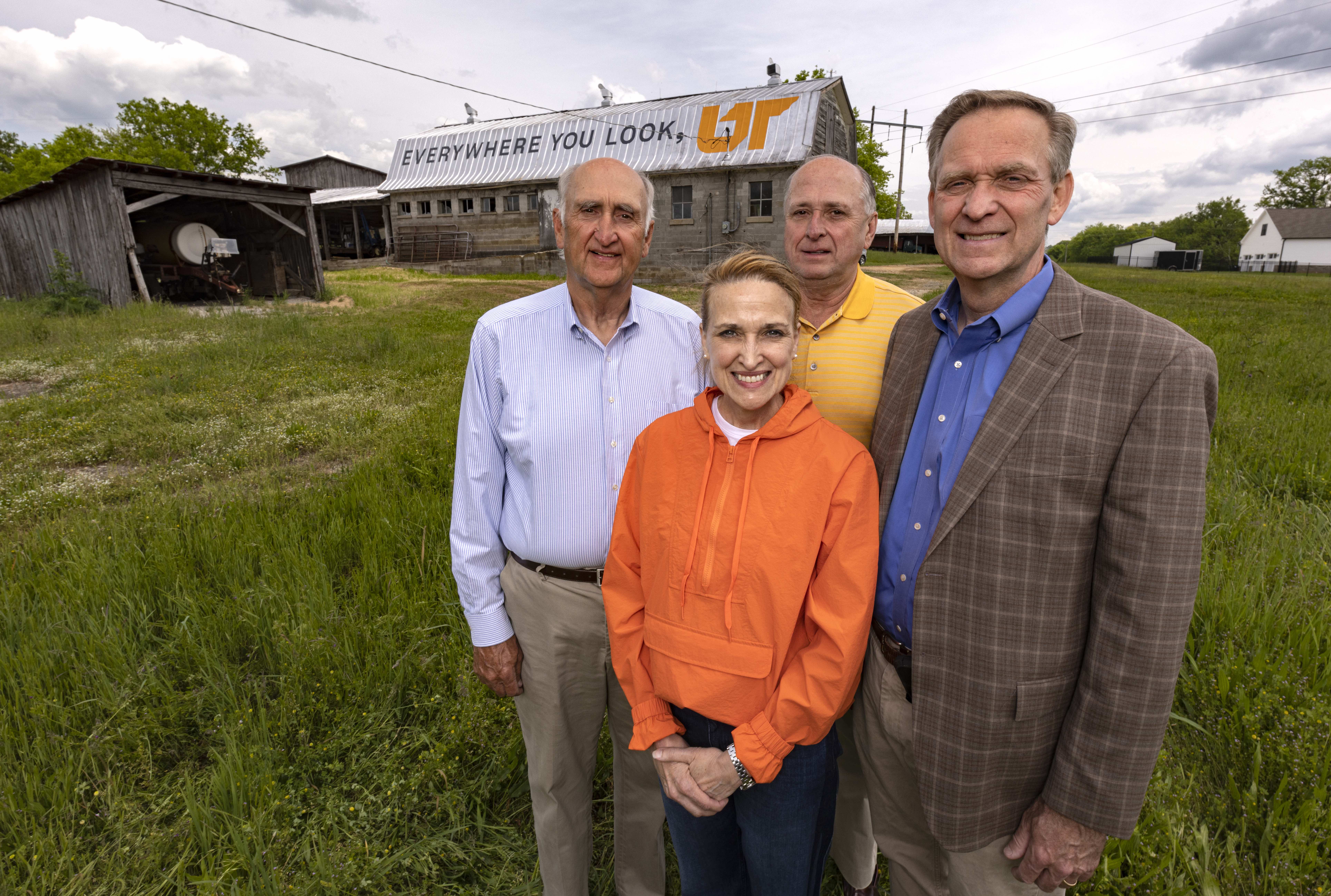 Harlan family members stand in front of UT mural in Columbia, Tennessee, located on Harlan Family Farm