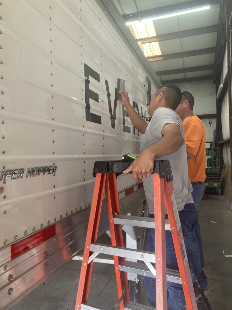 UT mural decal being applied to a 42-foot trailer by Smith Signs and Awnings in Lawrenceburg, Tennessee