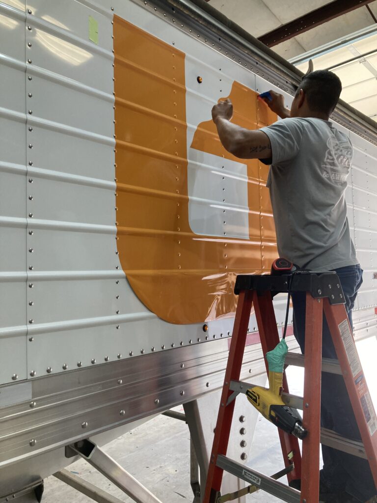 UT mural decal being applied to a 42-foot trailer by Smith Signs and Awnings in Lawrenceburg, Tennessee