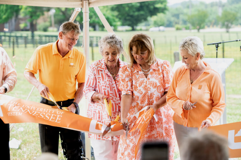 UT President Randy Boyd and members of the Johnson family cutting the ribbon to dedicate the UT mural on Johnson Farm May 26, 2023