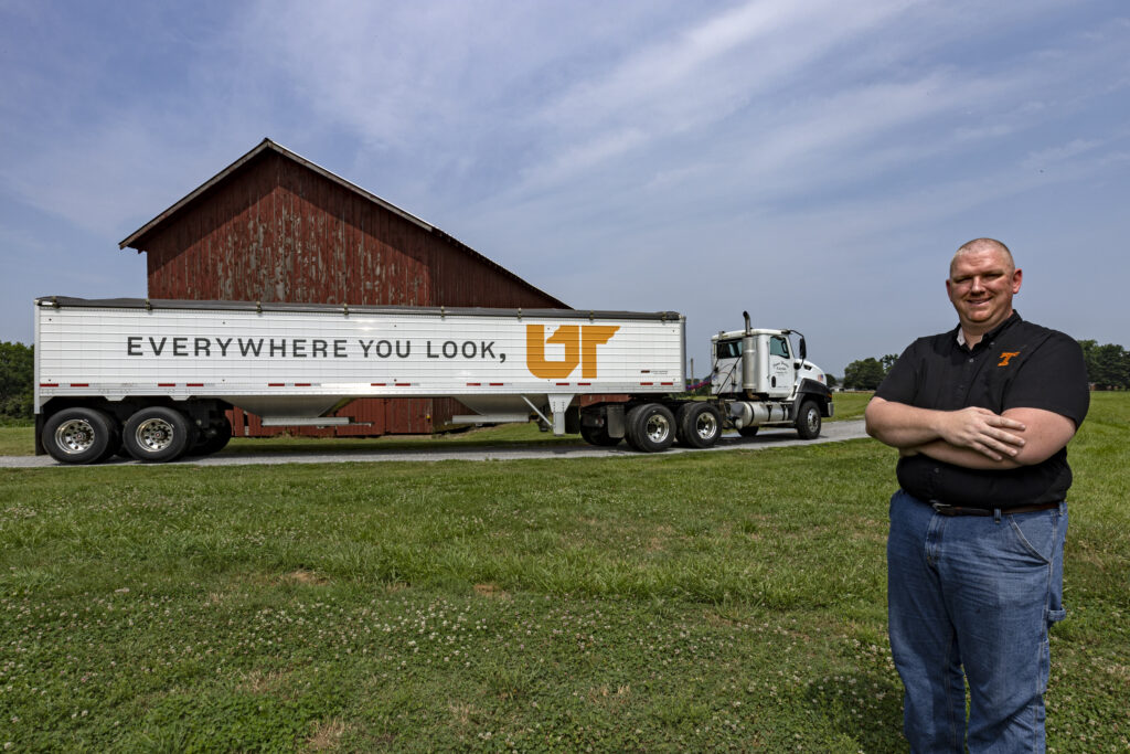 James Harlan stands with his 40-foot tractor trail bearing the Everywhere You Look, UT logo on a farm in Columbia, Tennessee
