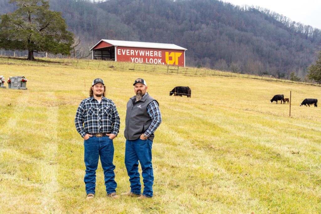 Owner Brian Dalton and son pose in front of UT mural on Dalton Farm in Thorn Hill, Tennessee