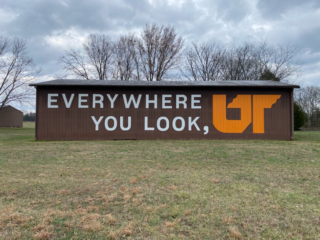 Orange and white "Everywhere You Look, UT" logo on brown barn