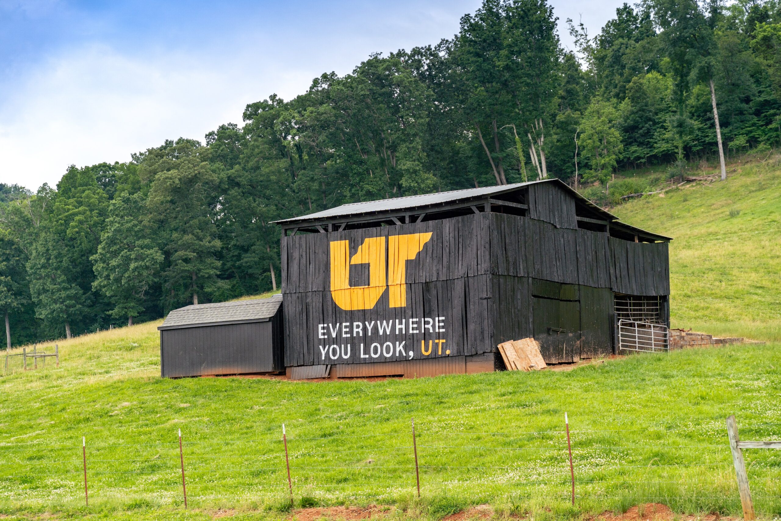 Orange and white Eveywhere You Look, UT mural painted on black barn