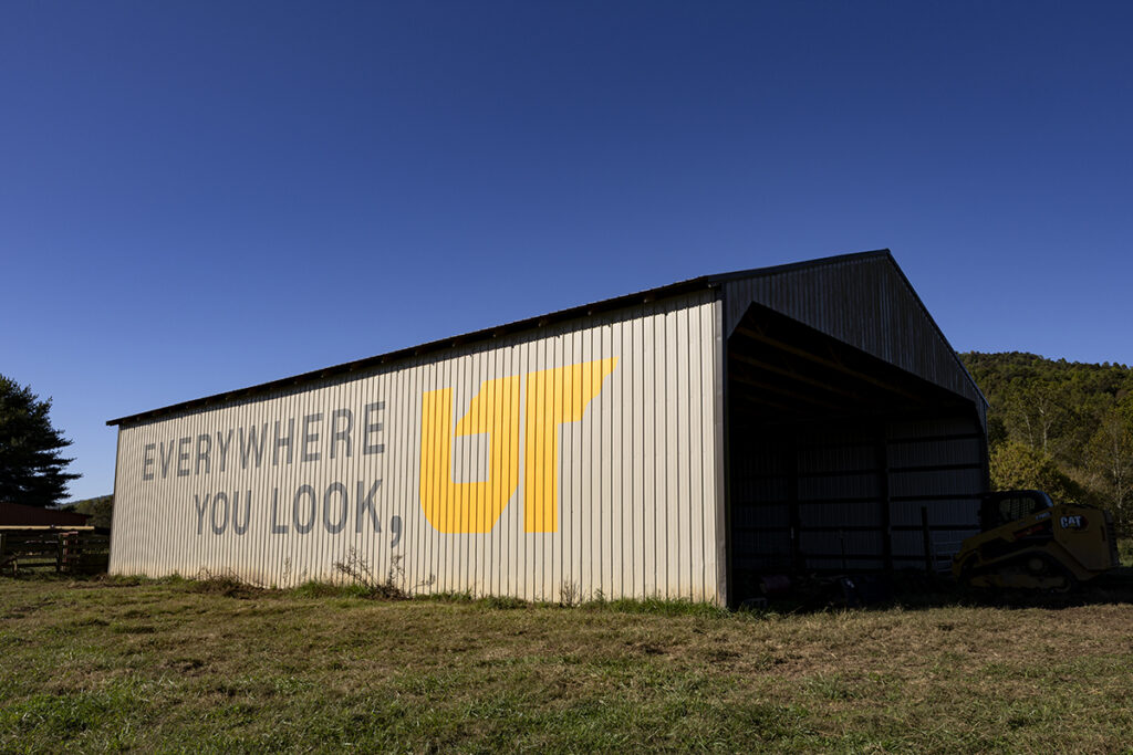 A brown barn with a painted mural.