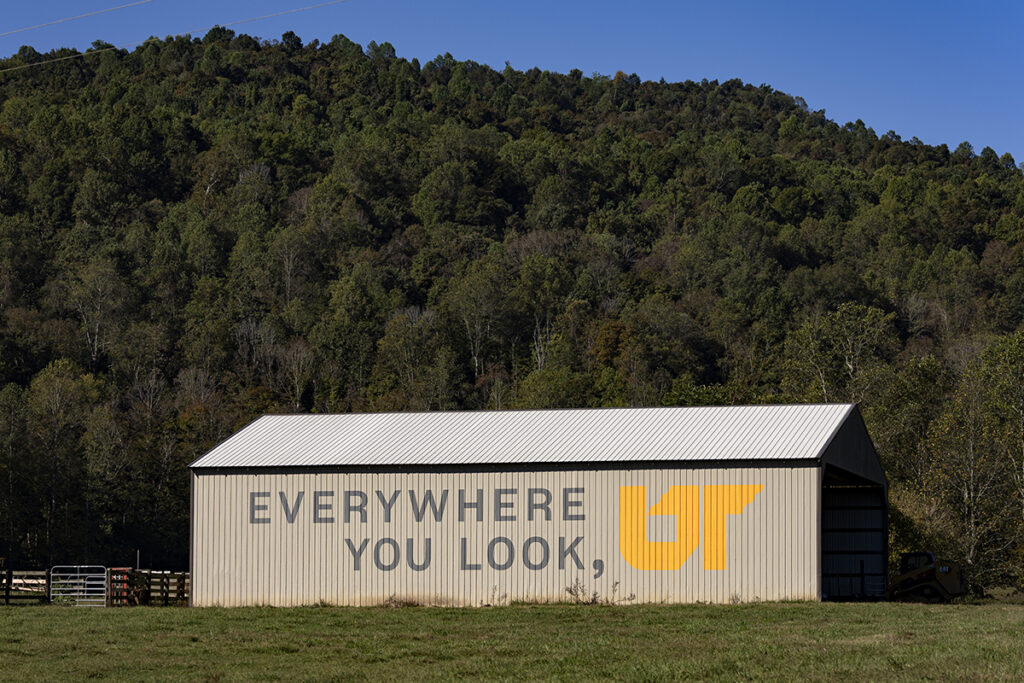 A brown barn with a painted mural.