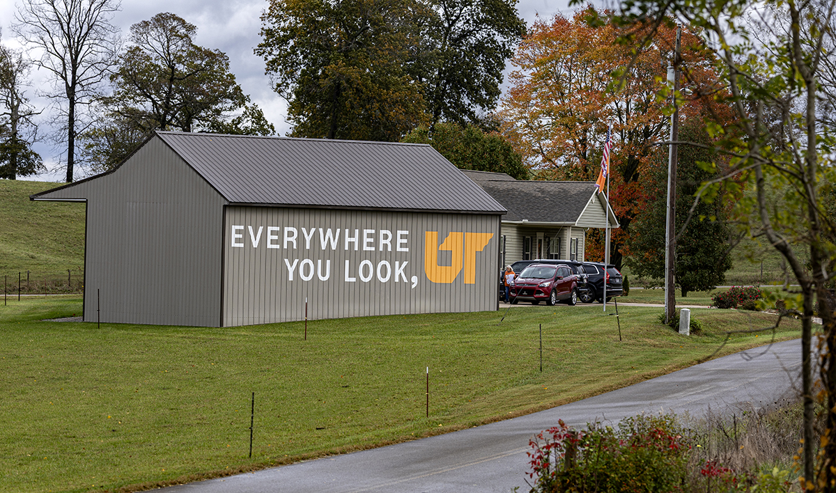 A brown barn with a painted mural.
