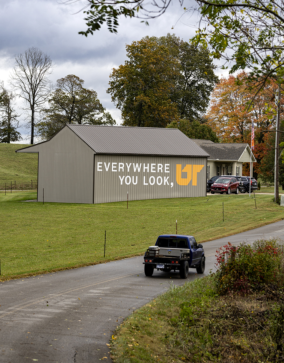 A brown barn with a painted mural.